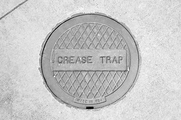 grease trap pumping involves removing the built-up grease and solid waste from the trap using specialized equipment
